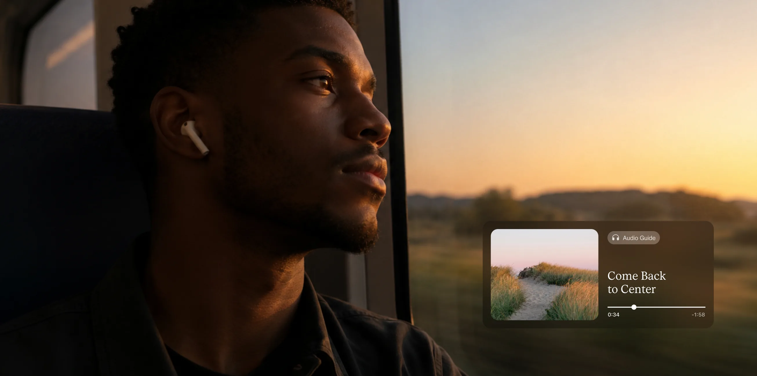 A man wearing an earbud looking out of a car window at dusk, beside an audio guide playing in the Empathy app
